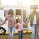 family with RV in the background